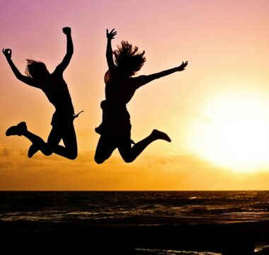 silhouette photography of jump shot of two persons